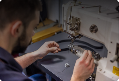 A man carefully operates a precision tool for detailed work.
