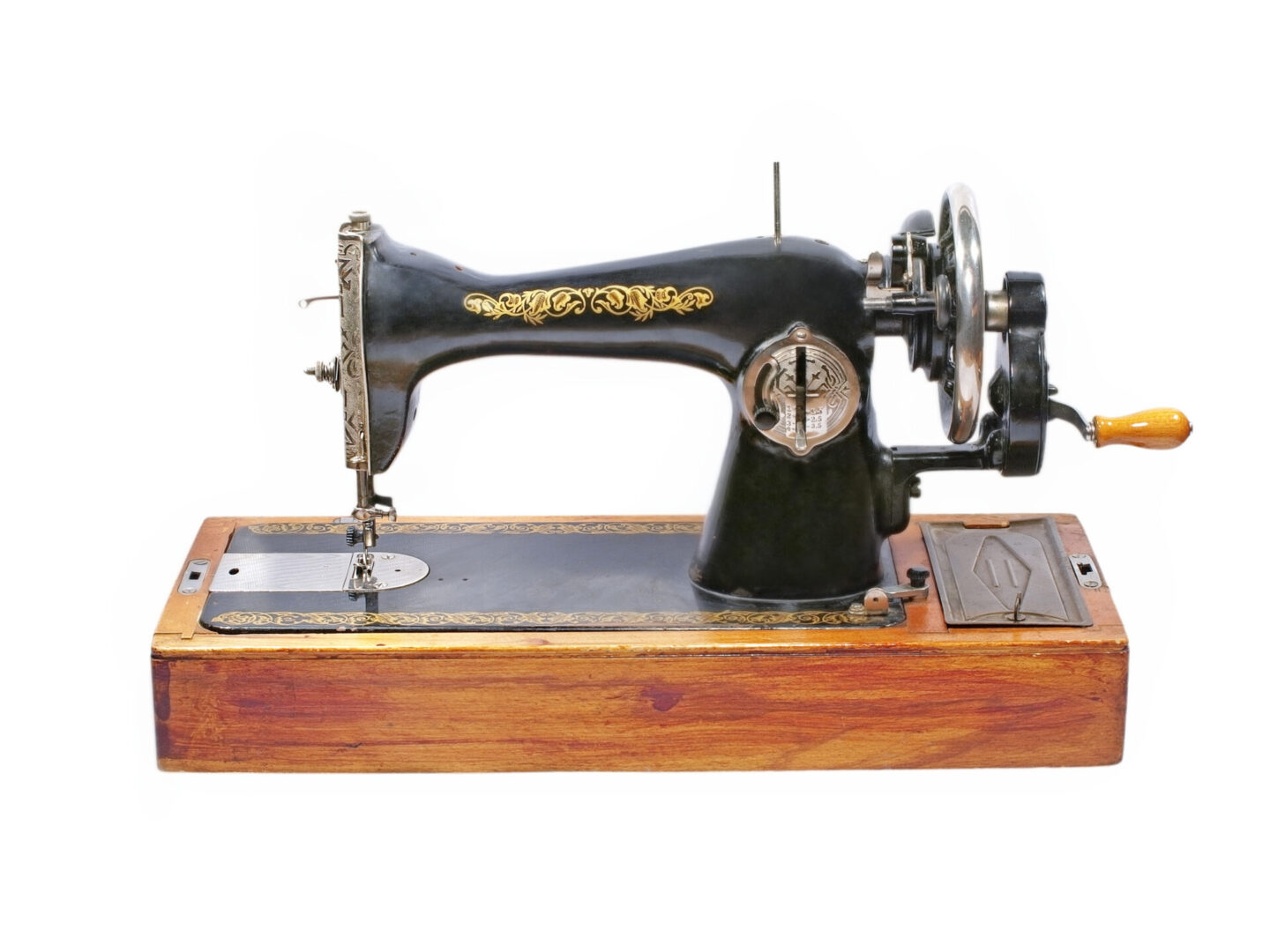 Vintage black sewing machine with gold detailing on wooden base.