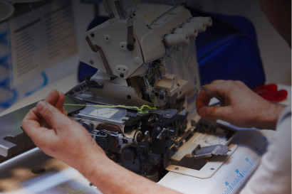 Person working on sewing machine components